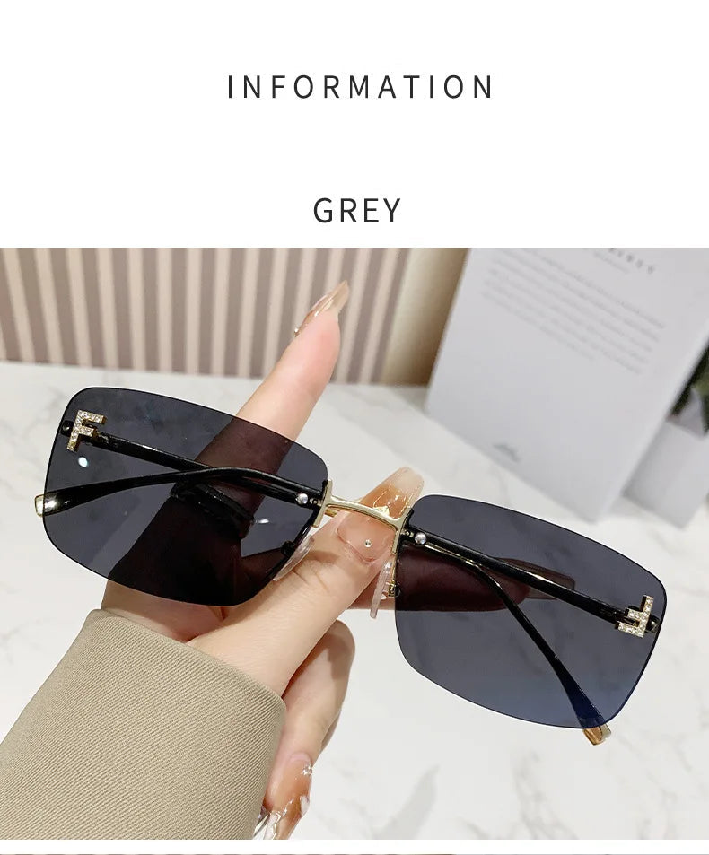 Sunglasses held by a hand with text indicating 'Grey' color on a light background