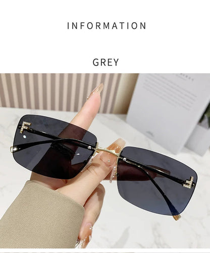 Sunglasses held by a hand with text indicating 'Grey' color on a light background