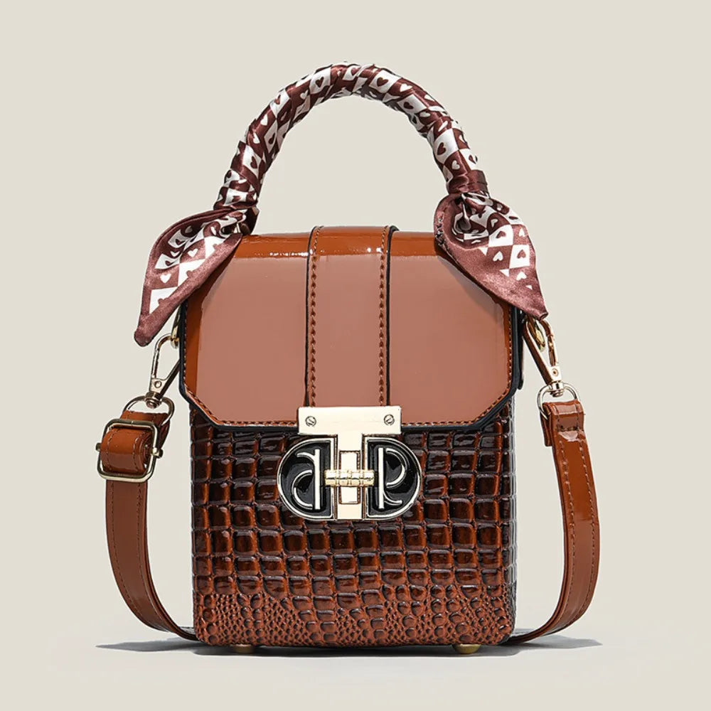 Brown handbag with patterned handle on a beige background