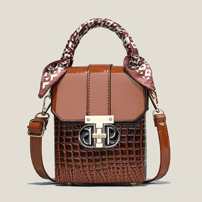Brown handbag with patterned handle on a beige background