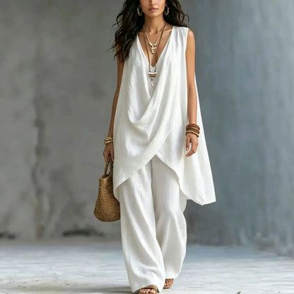 Woman wearing a flowing white Pant Set with a neutral background