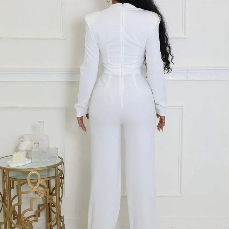 Person wearing a white jumpsuit in a room with decorative elements.