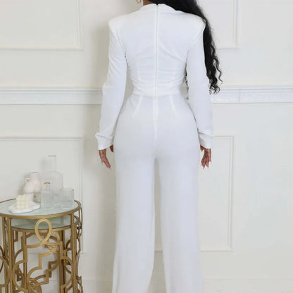 Person wearing a white jumpsuit in a room with decorative elements.