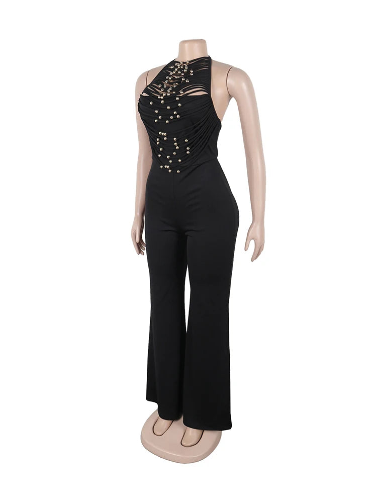 Black jumpsuit with embellishments on a mannequin against a white background
