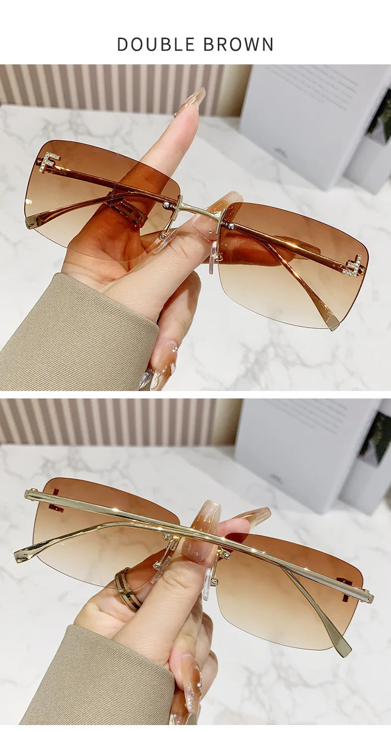 Brown sunglasses held by a hand with a blurred background