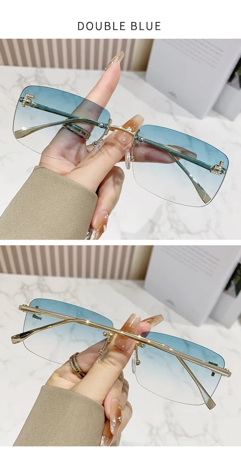 Tinted eyeglasses with gold frames held by a hand against a neutral background.