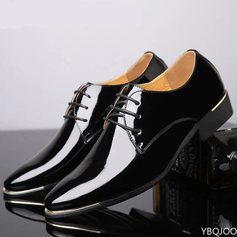 Black patent leather shoes with gold trim on a reflective surface.