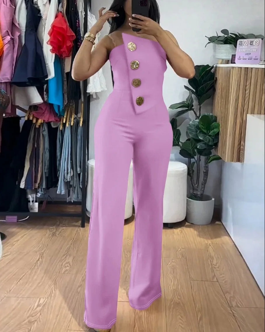 Person wearing a pink jumpsuit with gold buttons in a clothing store.