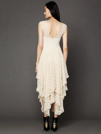 Woman wearing a cream lace dress with a dark background