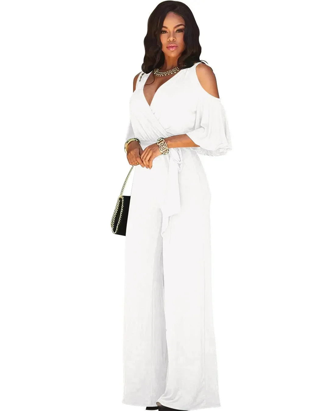 Woman wearing a white jumpsuit with a plain background