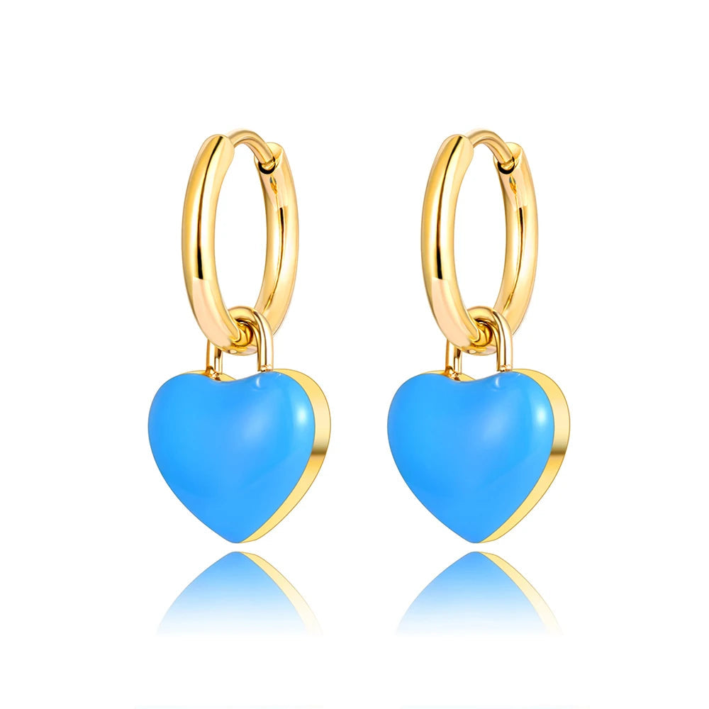 A pair of gold hoop earrings with heart-shaped light blue enamel pendants, shown on a white background.
