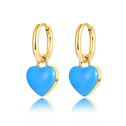 A pair of gold hoop earrings with heart-shaped light blue enamel pendants, shown on a white background.
