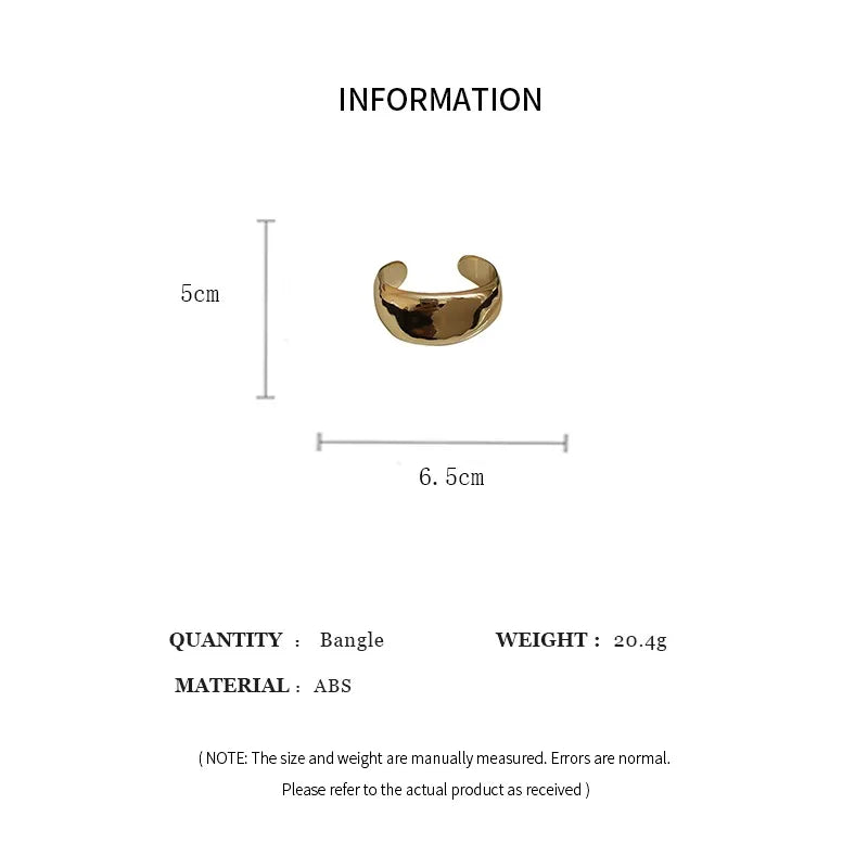 Gold bangle with measurements on a white background