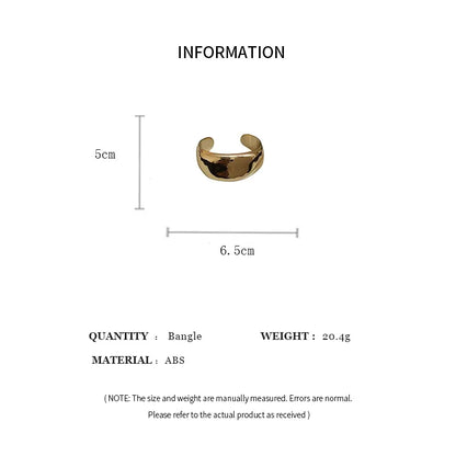 Gold bangle with measurements on a white background