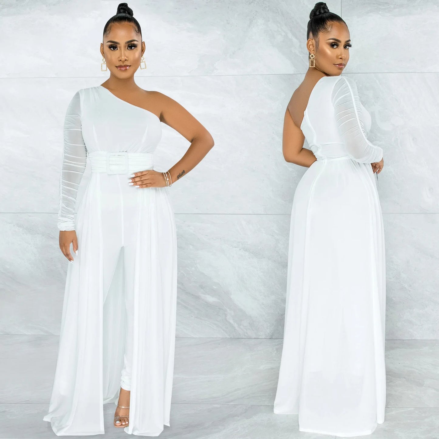 A chic white jumpsuit featuring a single-shoulder silhouette, sheer sleeve detailing, and a belted waist. The flowing overlay adds drama, and the front and back views are accentuated by gold jewelry, all set against a polished marble background.