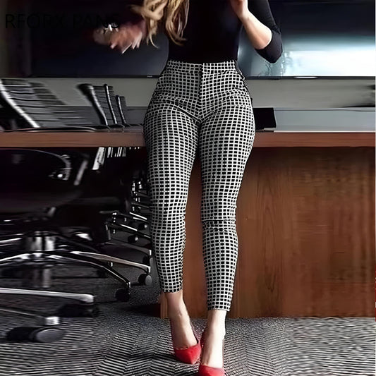 A person wearing high-waisted checkered pants and red heels stands next to a conference table with office chairs. The mood appears professional.