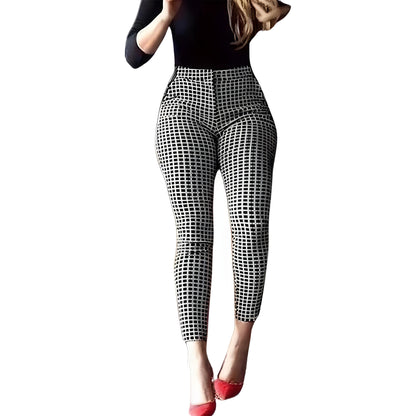 A woman in a black top models high-waisted, black-and-white checkered pants against a white background. She wears red heels, creating a bold contrast.