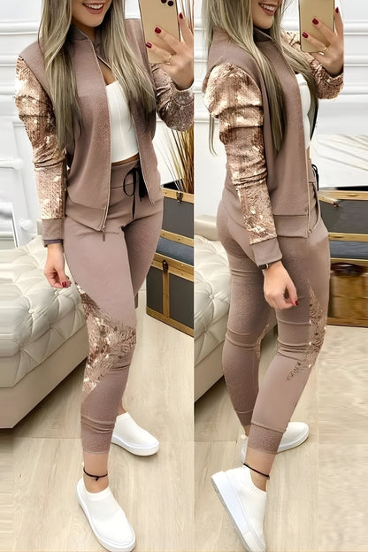 Woman taking a mirror selfie wearing a matching outfit with a jacket and pants.