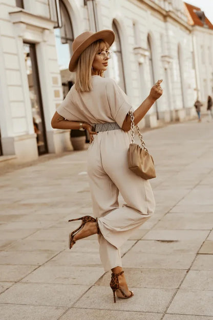 Beige wide leg jumpsuit paired with a hat