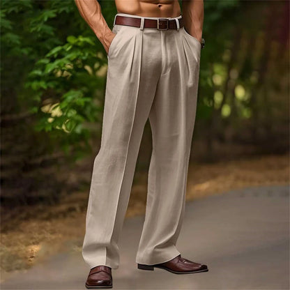 Person wearing beige pleated pants with a brown belt and shoes, standing outdoors.