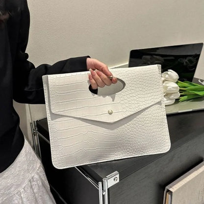 Bold Envelope Evening Clutch in crocodile-textured PU with an oval cutout handhold and flap-style design.