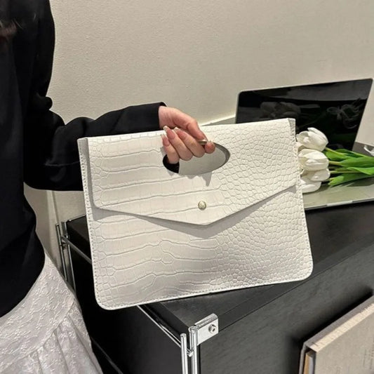 Bold Envelope Evening Clutch in crocodile-textured PU with an oval cutout handhold and flap-style design.
