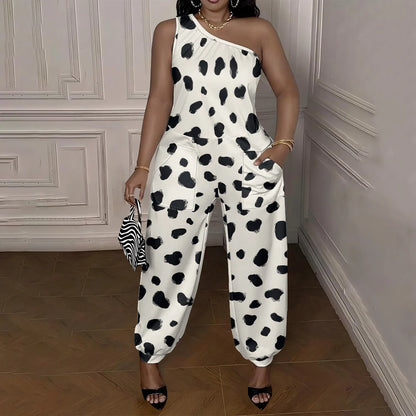 Woman wearing a black and white polka dot jumpsuit in an indoor setting.