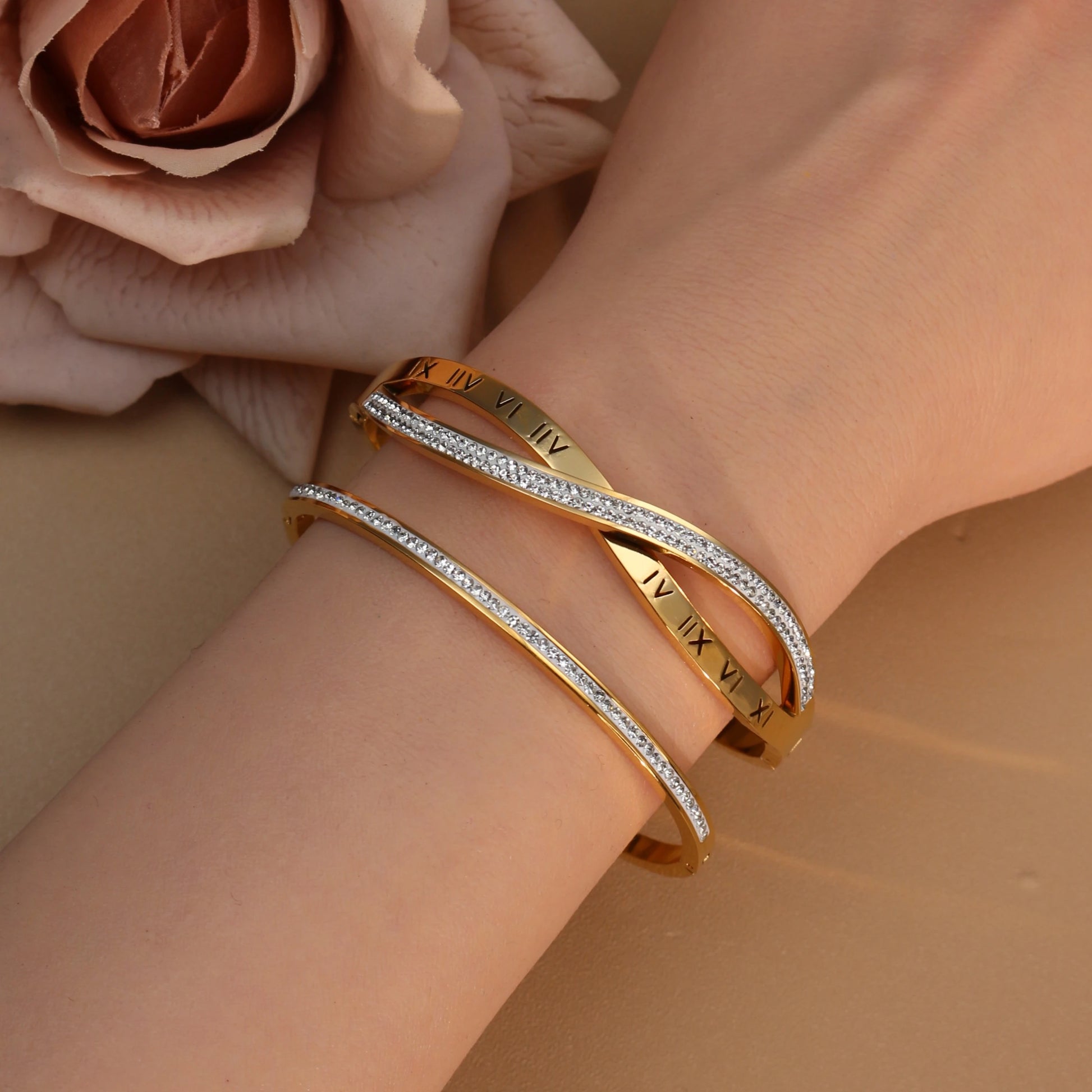 Close-up detail of crystal accents on stainless steel bangle bracelet