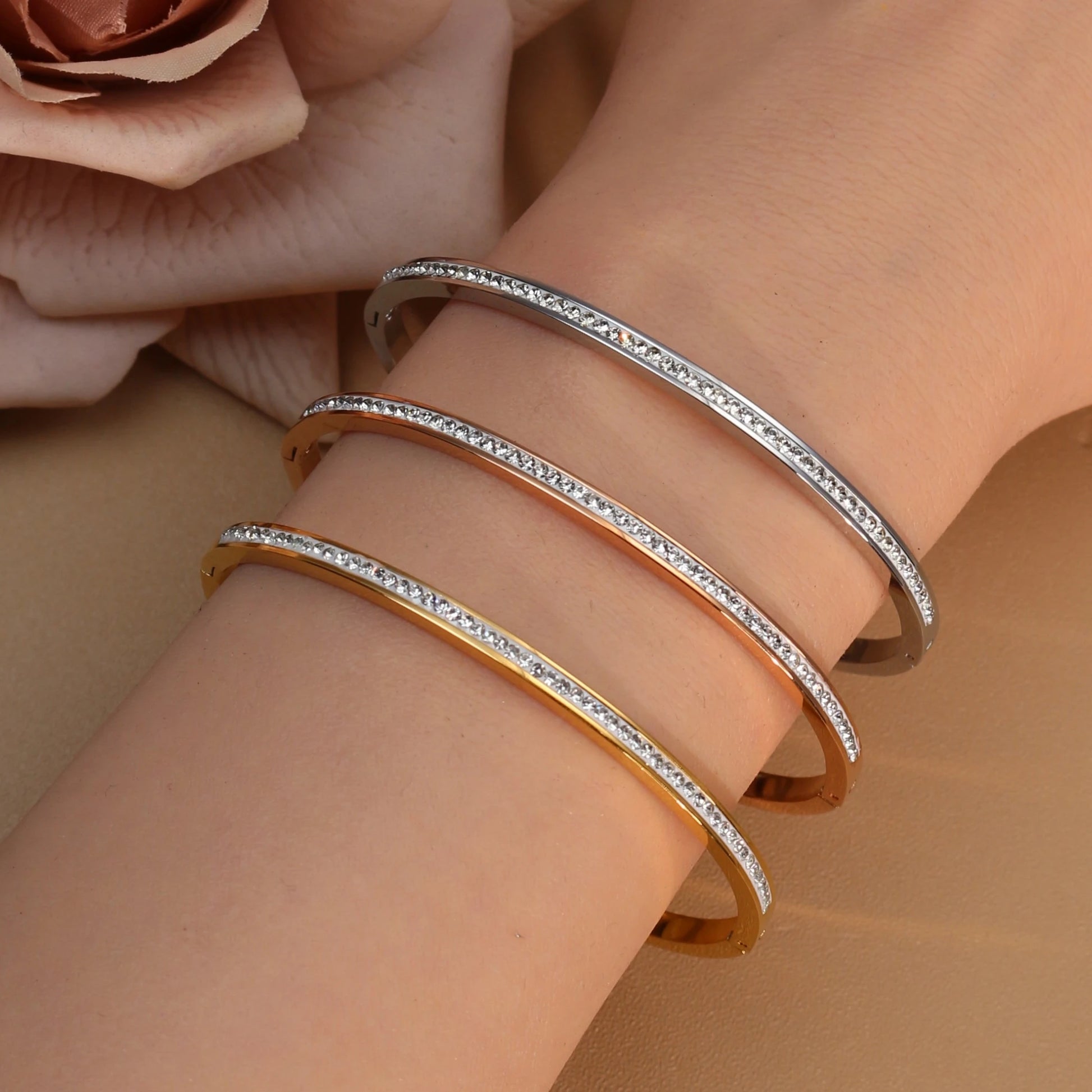 Stainless steel bangle bracelet with crystal accents in rose gold, silver, and gold
