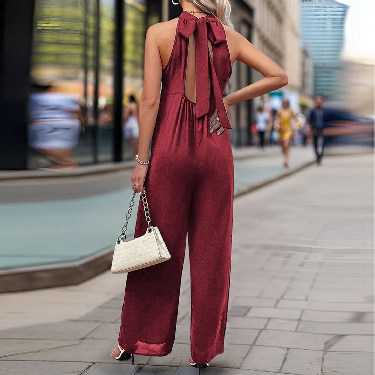 Back view of halter-neck wide-leg jumpsuit with bow-tie detail.