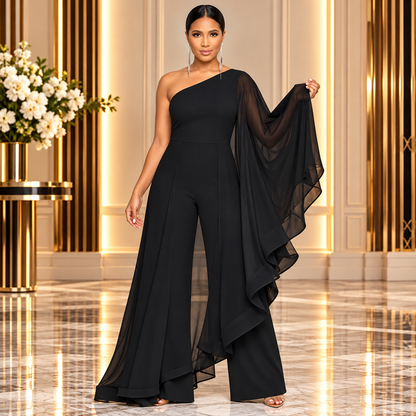Woman modeling an elegant classic black one-shoulder ruffle jumpsuit featuring an asymmetrical neckline, dramatic sheer chiffon cape sleeve, cascading layered ruffles, and flowing wide-leg pants. Styled with sparkling silver drop earrings and metallic heels in a luxurious gold-accented interior.