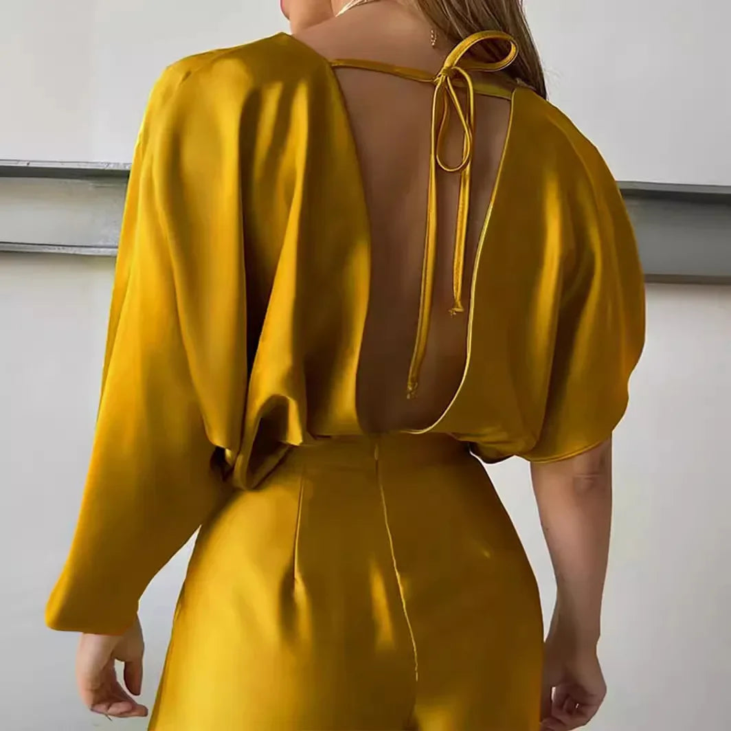 gold jumpsuit styled with a statement belt