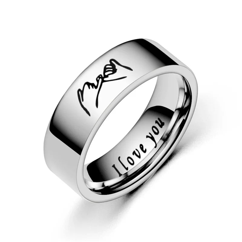 Matching couple promise rings in titanium steel showing hand-in-hand design