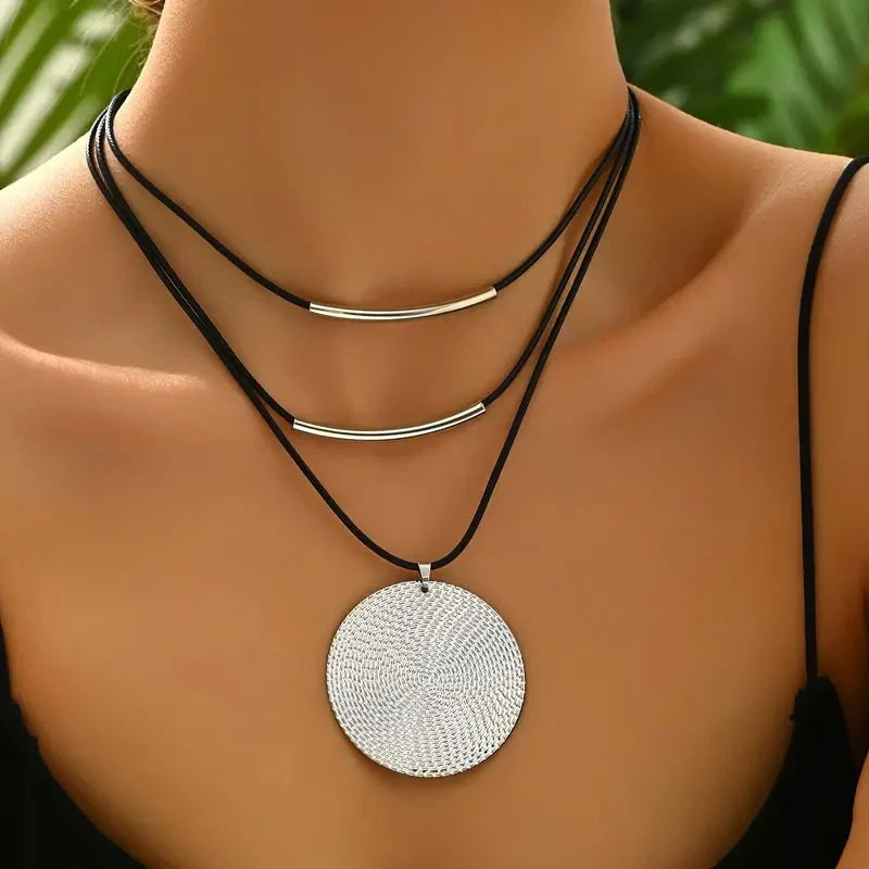 Leather pendant necklace showing warm gold accents and premium genuine leather band