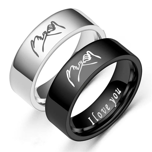Two rings, one silver and one black, with engraved text on a white background