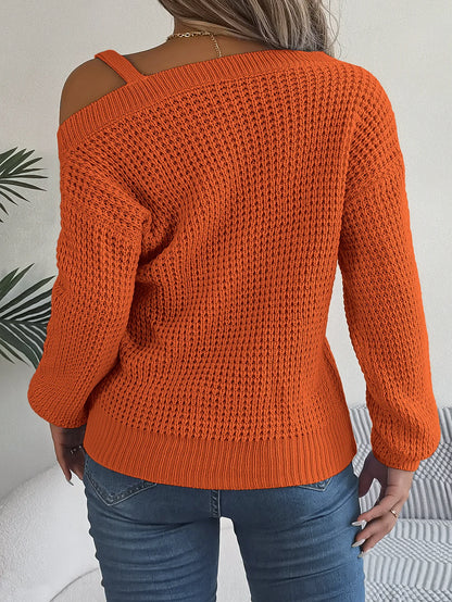 Orange knitted sweater worn by a person with a neutral background