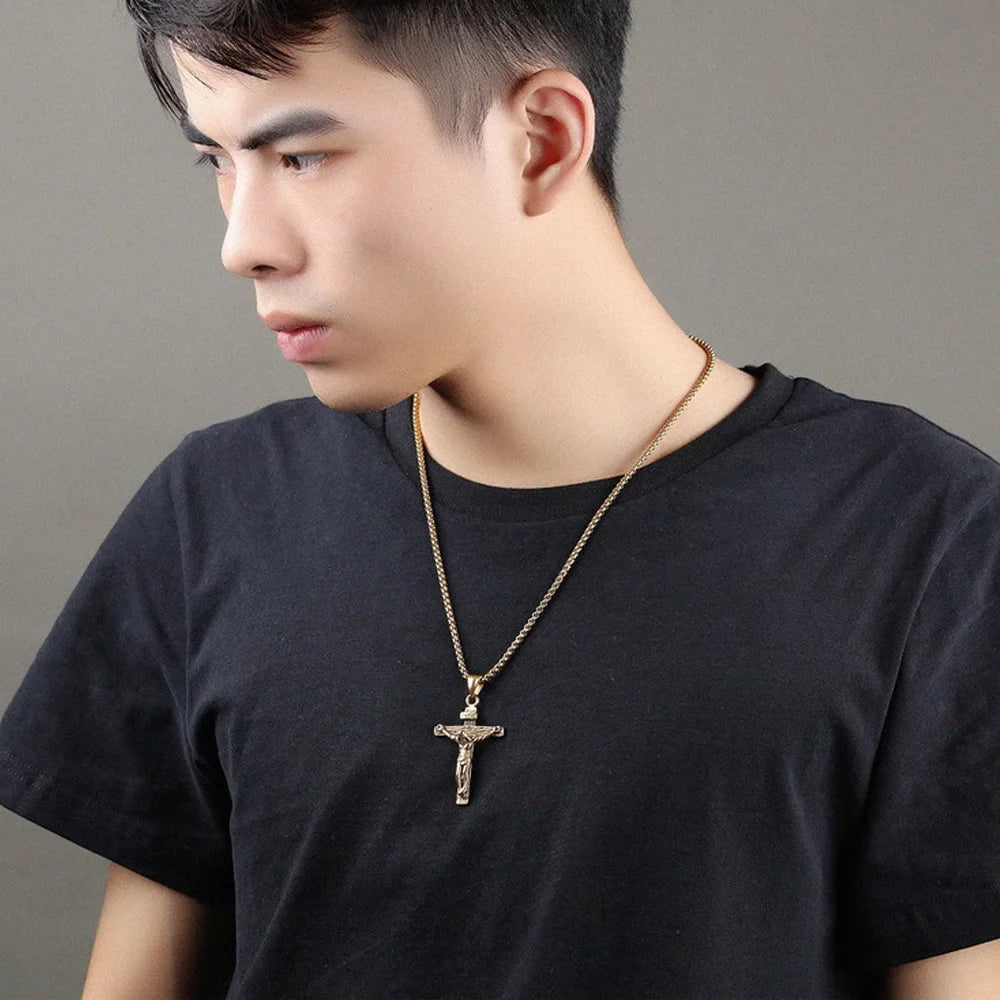 Person wearing gold cross necklace showing unisex faith jewelry style