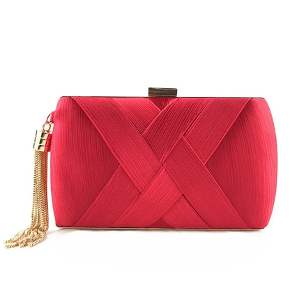 Open red evening clutch revealing satin-lined interior and storage capacity