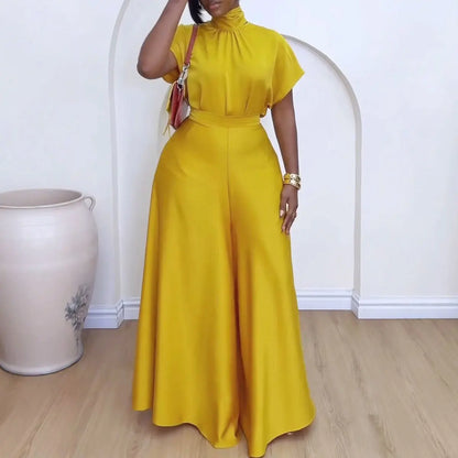 "Woman wearing mustard yellow wide-leg pantsuit with mock neck top and coordinating belt"