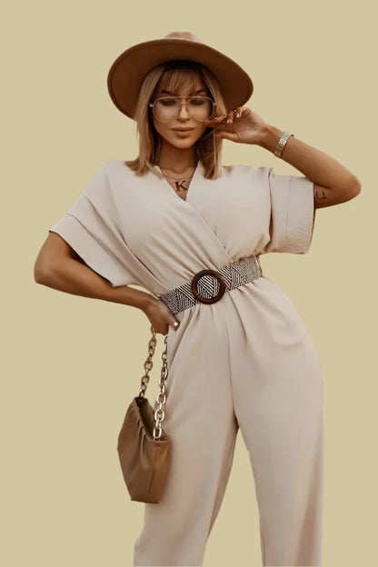 Beige wide leg jumpsuit paired with a hat