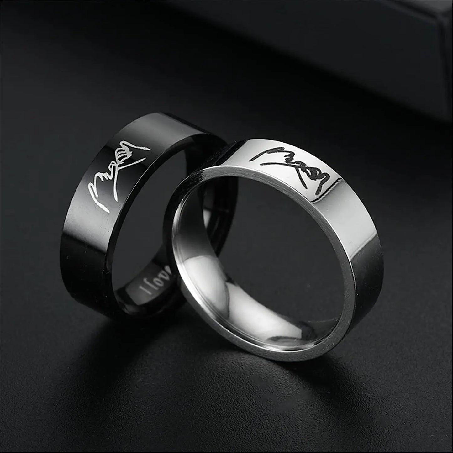  Black ring with 'I love you' engraving on a dark background