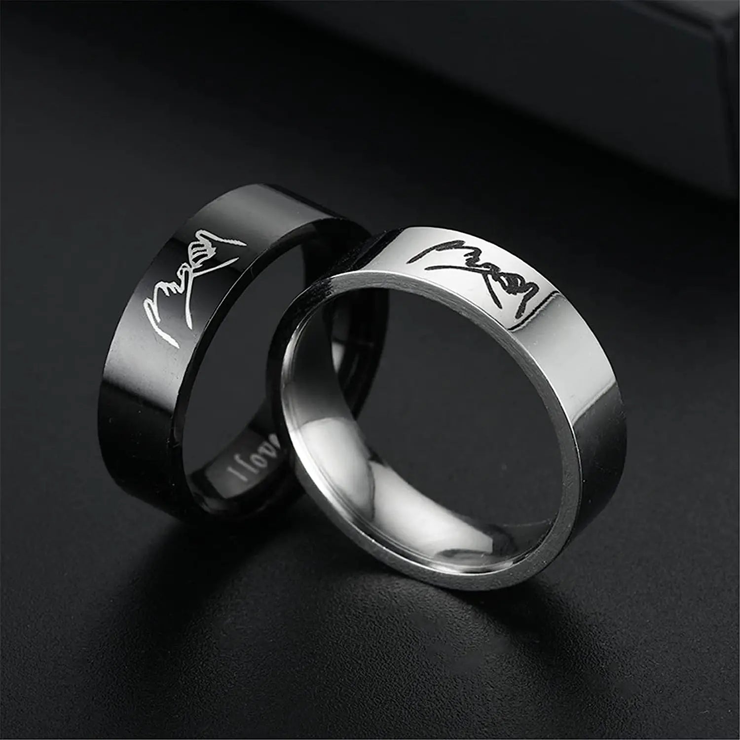  Black ring with 'I love you' engraving on a dark background