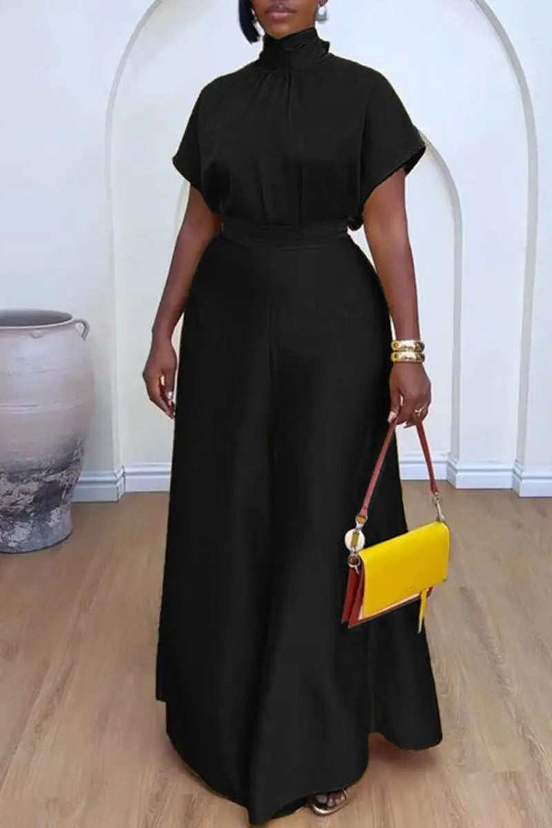 "Black two piece set featuring wide-leg pants and short sleeve mock neck top on model"